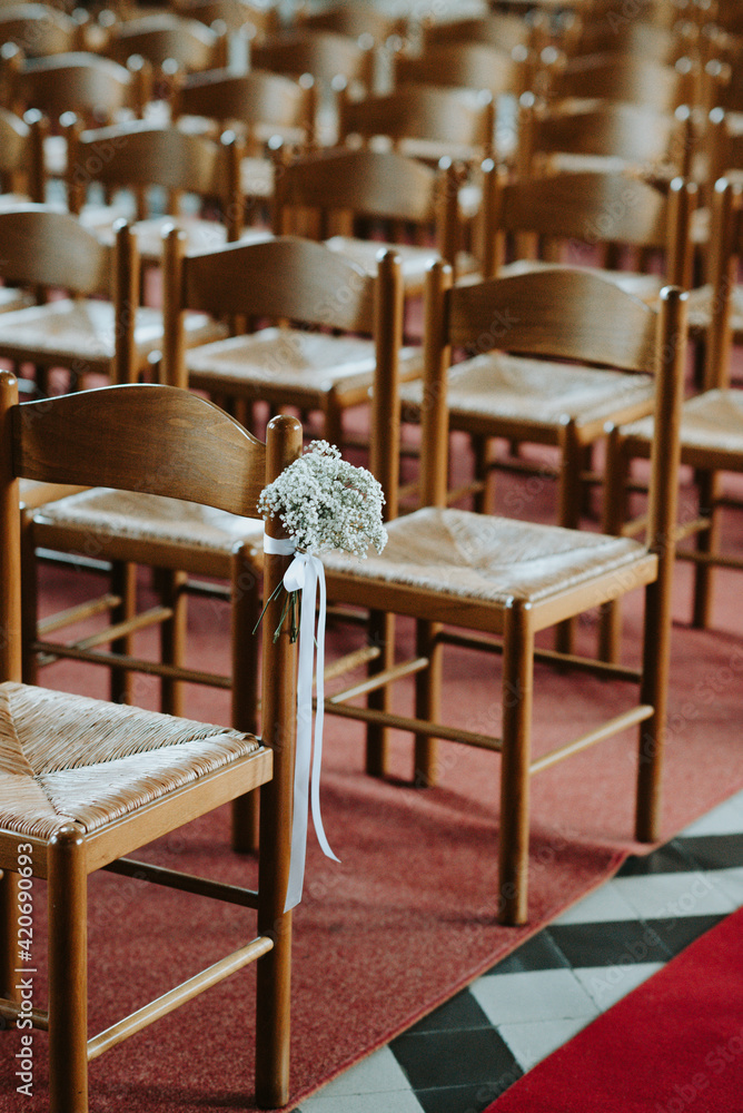 Rows of chairs in church with flower bouquet Rows of chairs in church with flower bouquet