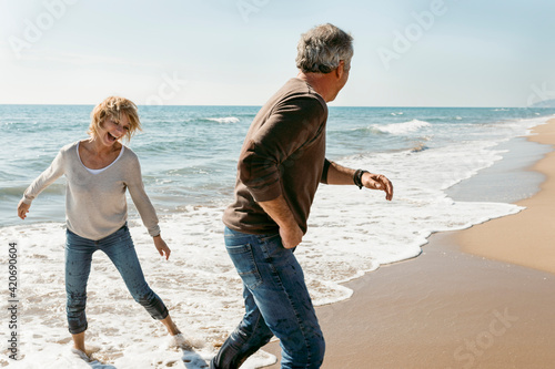 Mature couple propose at the fall beach morning