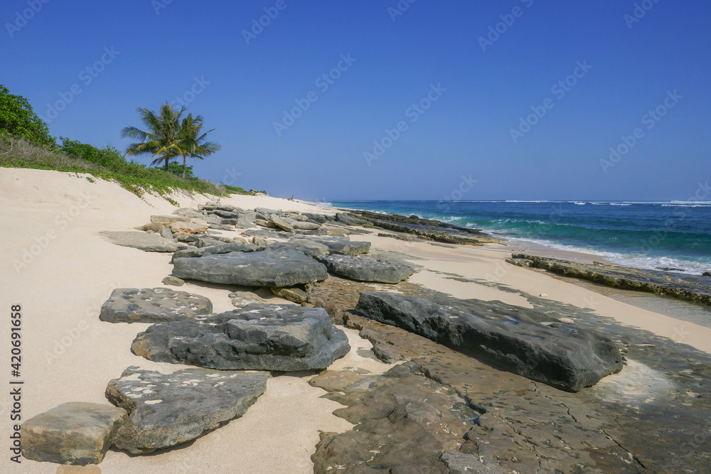 Landscape view of scenic Marosi beach with beautiful flat rocks, Lamboya, Sumba island, East Nusa Tenggara, Indonesia