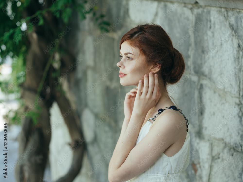 Naklejka premium Woman in white dress outdoors green leaves close-ups fresh air