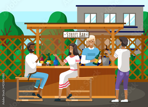Guests relaxing in street outdoor bar. Bartender making alcohol coocktails for communicating people