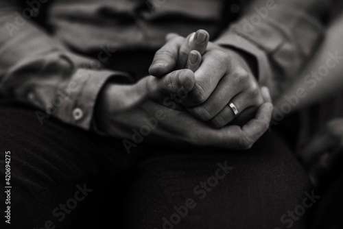 monochrome image of two people holding hands photo