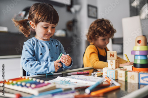 Girl drawing a picture with his brother