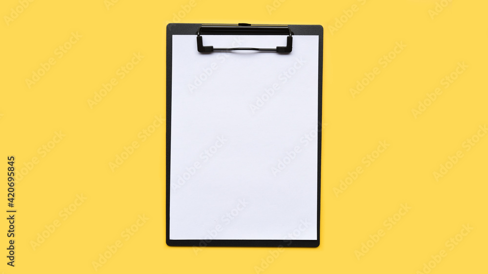 close up of empty paper on yellow background close up of empty paper on yellow background