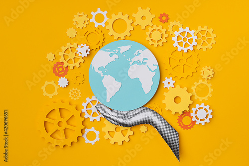 Hand holding the world with gears