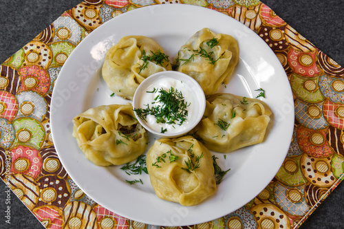 A traditional Asian steamed hot dough dish. Large dumplings on a plate.