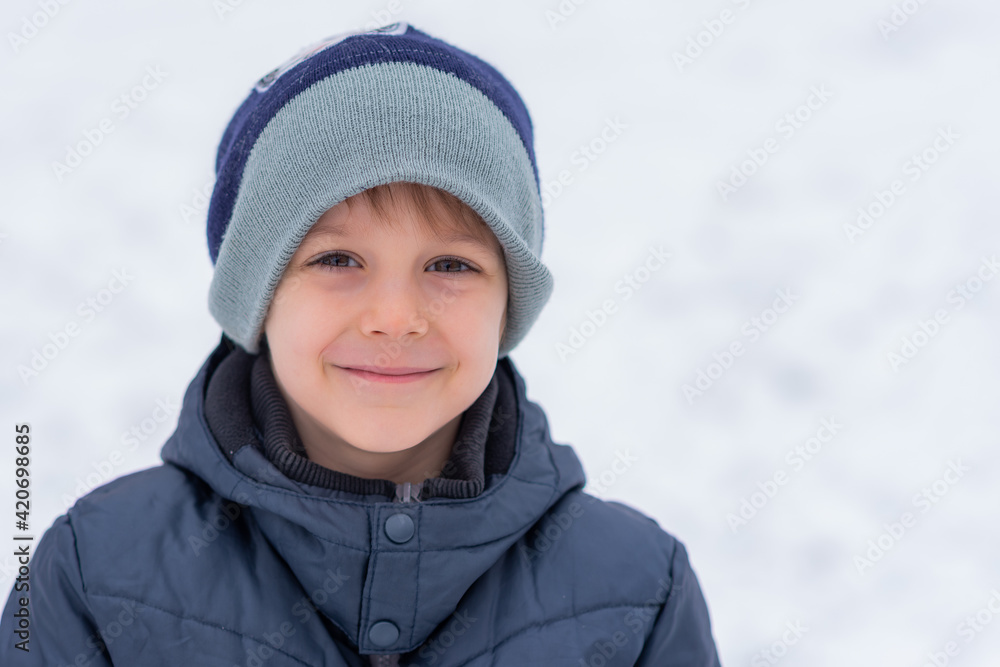 Winter portrait of little boy on a freezing day. Winter fun, kid winter playing -cute boy has a fun in snow Winter portrait of little boy on a freezing day. Winter fun, kid winter playing -cute boy has a fun in snow