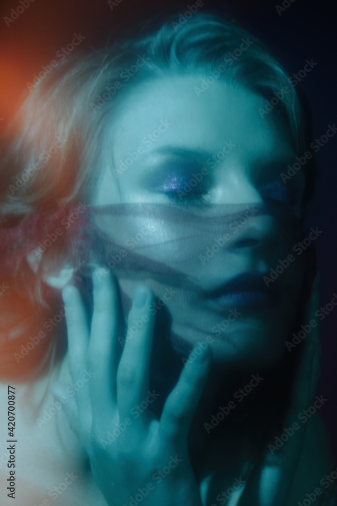 Blue light dreamy portrait of young model un decorative mask Blue light dreamy portrait of young model un decorative mask