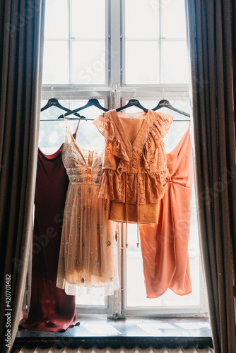 bridesmaids dress hanging in a window sill photo