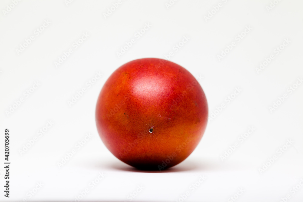 Ripe and juicy tamarillo fruit isolated in white Ripe and juicy tamarillo fruit isolated in white