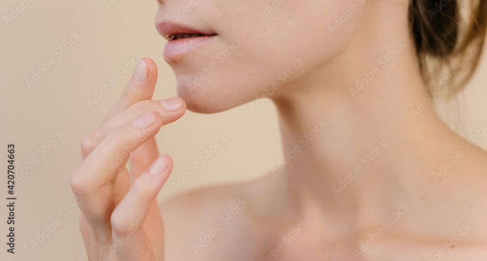 Charming woman applying lip balm in studio Charming woman applying lip balm in studio