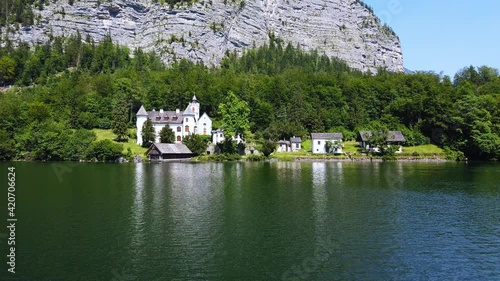 Summer rural landscape with lake and white house in Hallstatt, Upper Austria. European alps and Hallstatter lake in Salzkammergut region