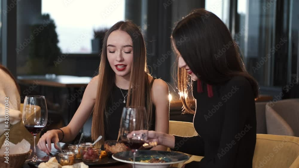 4K Happy female friends enjoying an evening out, chatting laughing. People, celebration and lifestyle concept 4K Happy female friends enjoying an evening out, chatting laughing. People, celebration and lifestyle concept