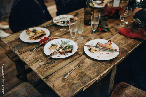 Rustic wooden table with leftovers from a Christmas dinner photo