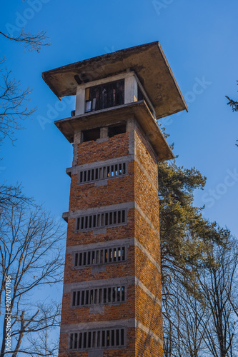 Sunny photo of abandoned ski jump tower in Mostec, Ljubljana. Relic of an old ski jumping hill in the Slovenian city. Frog view from outside. photo