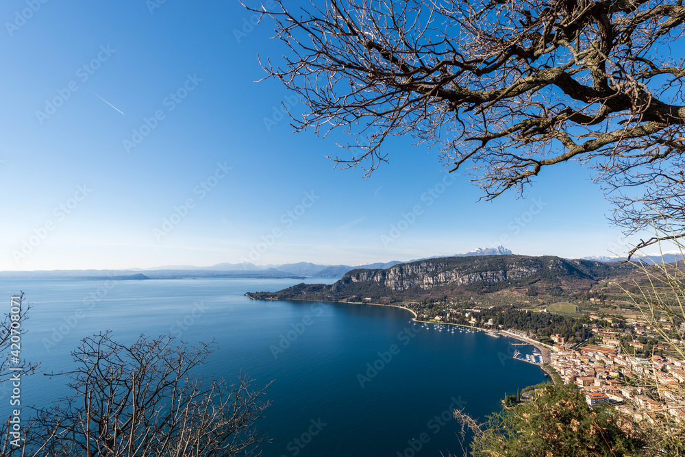 Aerial View of the Small Garda Town, tourist resort on the coast of Lake Garda, view from the Rocca di Garda, small hill overlooking the lake. Verona province, Veneto, Italy, Europe. Aerial View of the Small Garda Town, tourist resort on the coast of Lake Garda, view from the Rocca di Garda, small hill overlooking the lake. Verona province, Veneto, Italy, Europe.