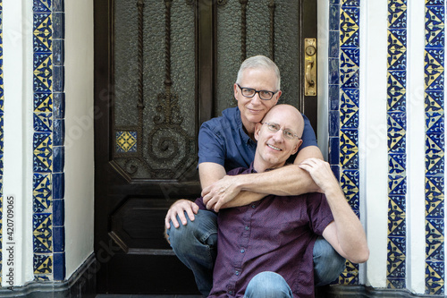 Silver age gay couple hugging