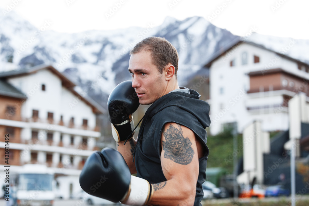Male boxer practicing on street Male boxer practicing on street