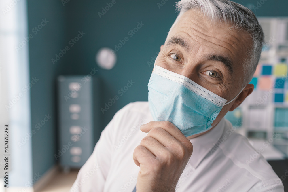 Happy businessman posing with face mask Happy businessman posing with face mask