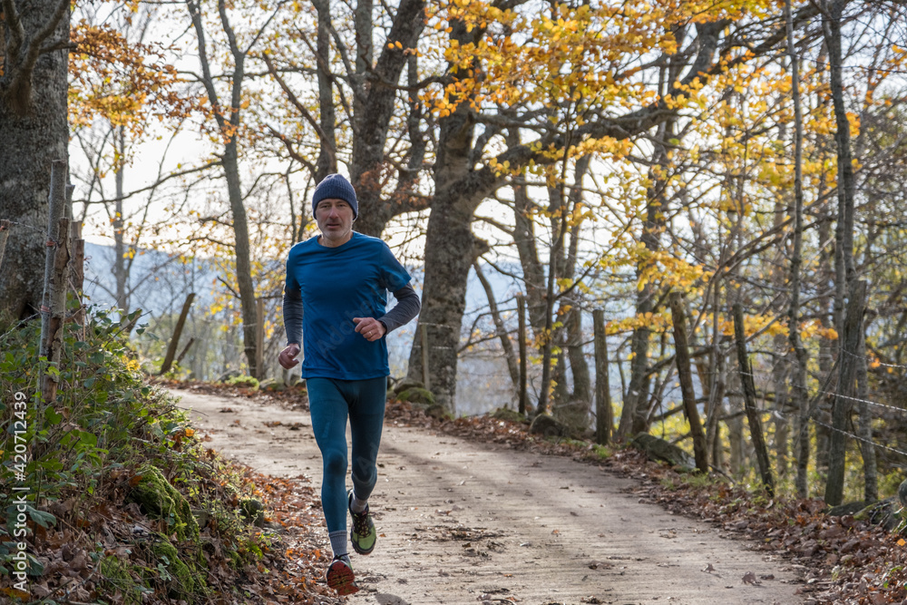 a man jogs on a rural road a man jogs on a rural road
