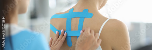 Tableau sur toile Professional doctor put tapes on patient back for effective treatment of scoliosis and pain relief