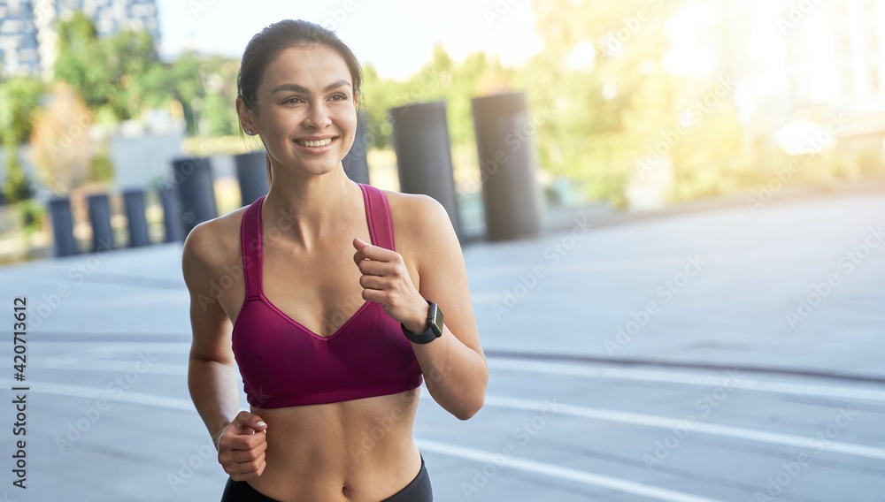 Happy pretty lady running early in the morning