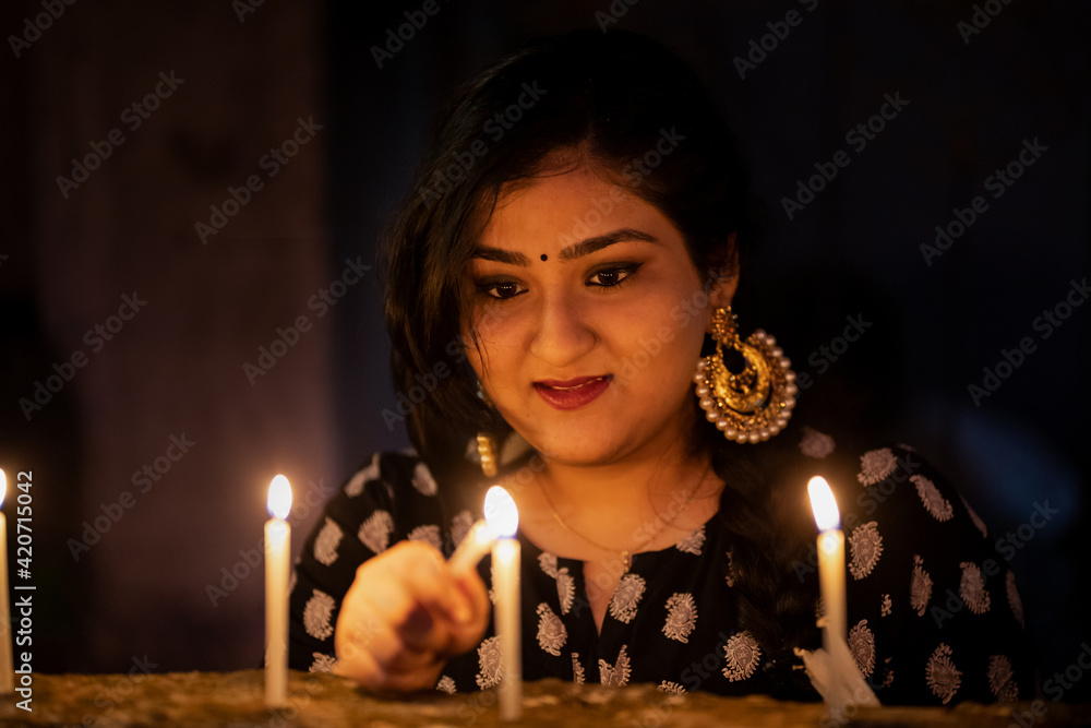 Portrait of young lady lighting candles on Diwali Stock Photo Adobe Stock