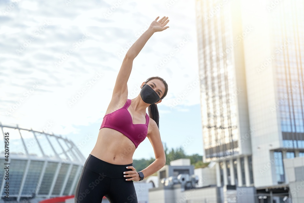 Athletic attractive lady doing a warm-up outside Athletic attractive lady doing a warm-up outside