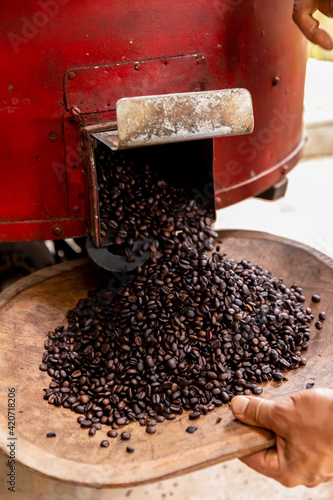 Coffee beans poured out of Roaster photo