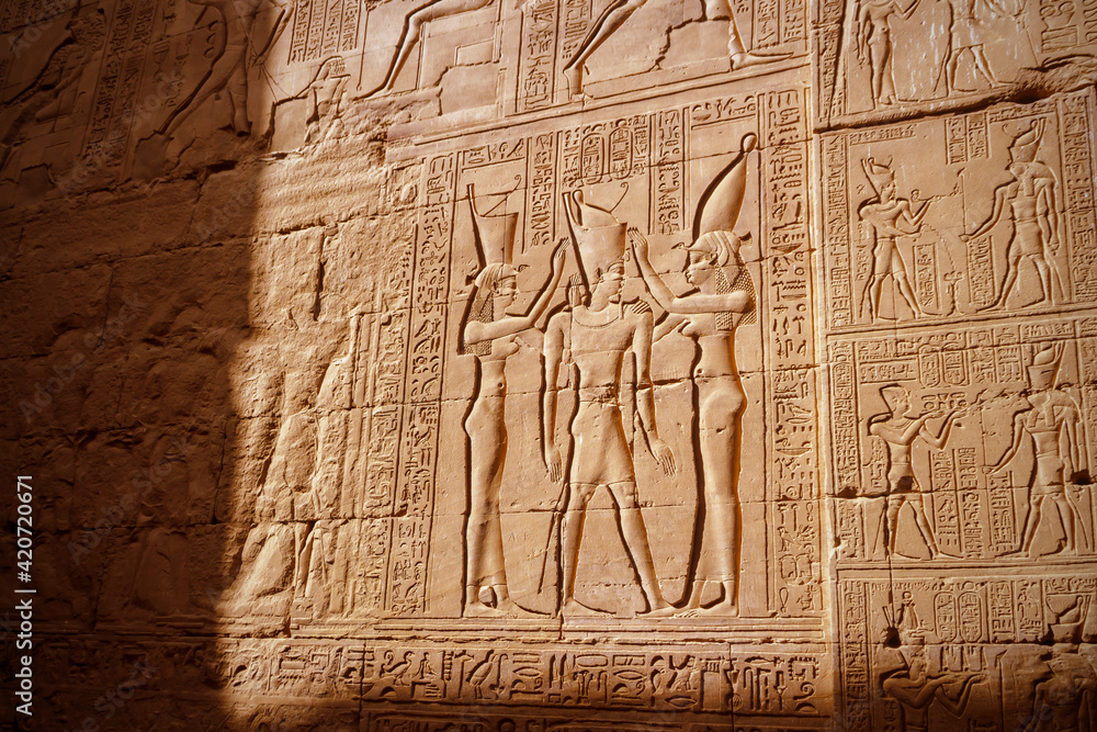 Hieroglyphic carvings on the exterior walls of an ancient egyptian temple