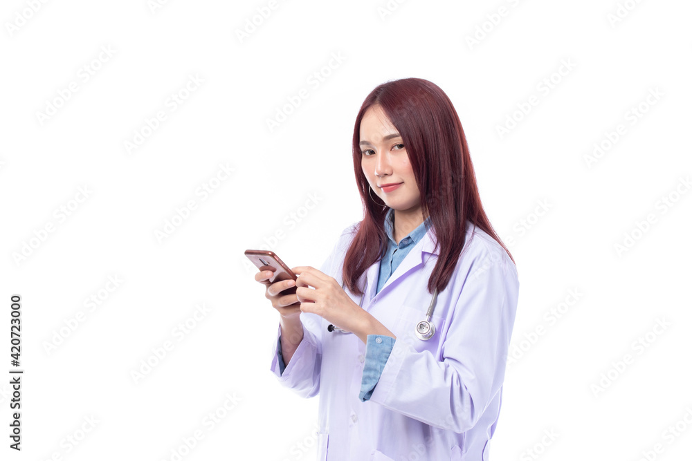 Beautiful portrait friendly asian female doctor or nurse with mobile phone in hands and text messaging at medical clinic isolated on white background. Beautiful portrait friendly asian female doctor or nurse with mobile phone in hands and text messaging at medical clinic isolated on white background.