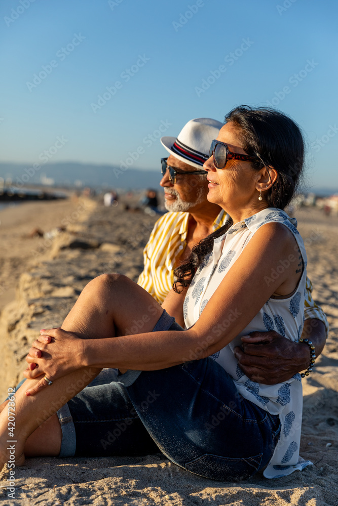 Senior Couple Sits On the Sand Senior Couple Sits On the Sand
