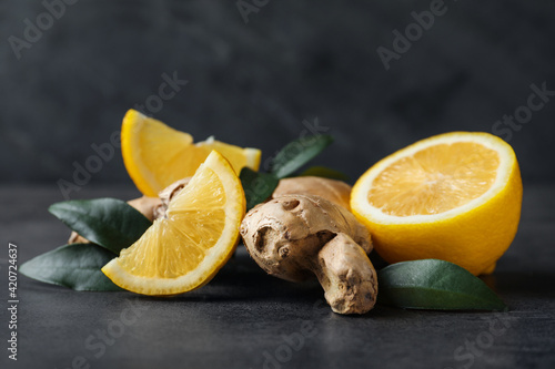 Fresh lemon and ginger on grey table, closeup