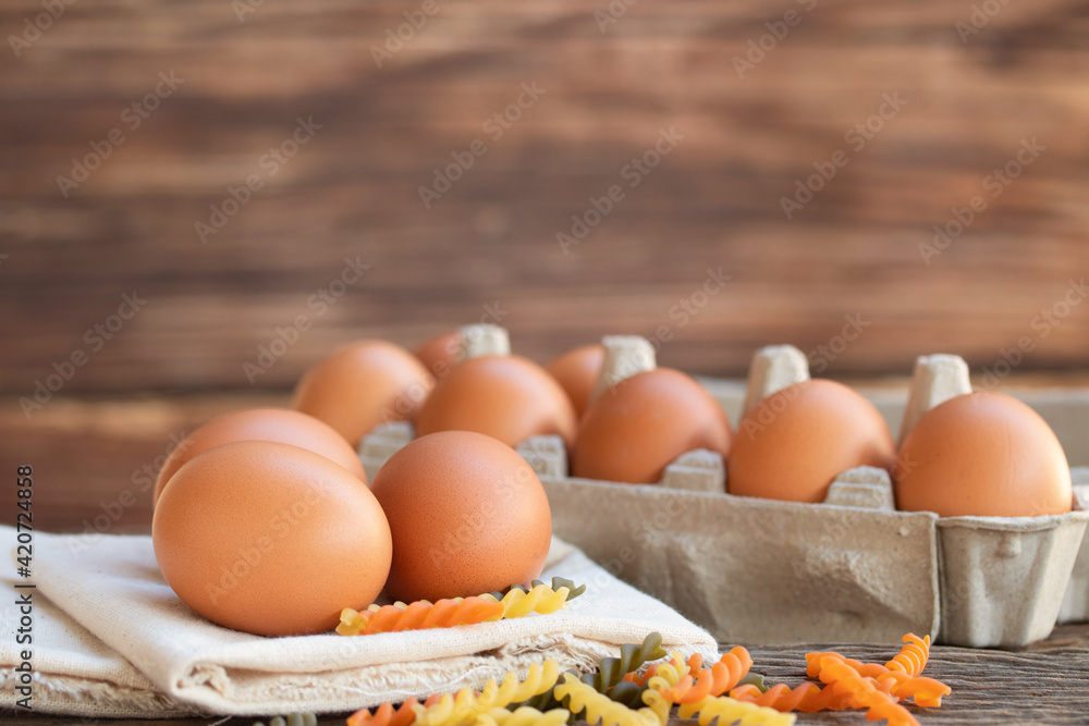 Chicken eggs, brown eggs, organic egg on calico at wooden rustic table. Natural eggs product concept. Chicken eggs, brown eggs, organic egg on calico at wooden rustic table. Natural eggs product concept.