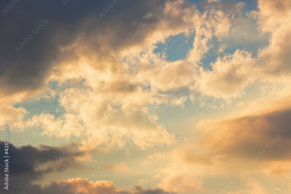 clouds in idyllic evening light. nature background in warm yellow and orange tones