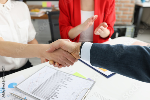 Fotografie Closeup of partners handshaking at business meeting