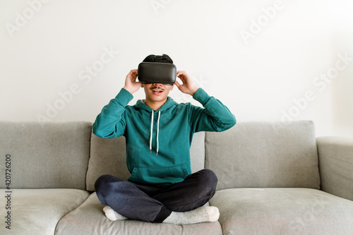 Man Adjusts Straps on Virtual Reality Headset photo