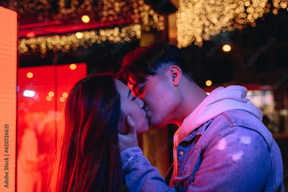Chinese young couple kissing in street Chinese young couple kissing in street