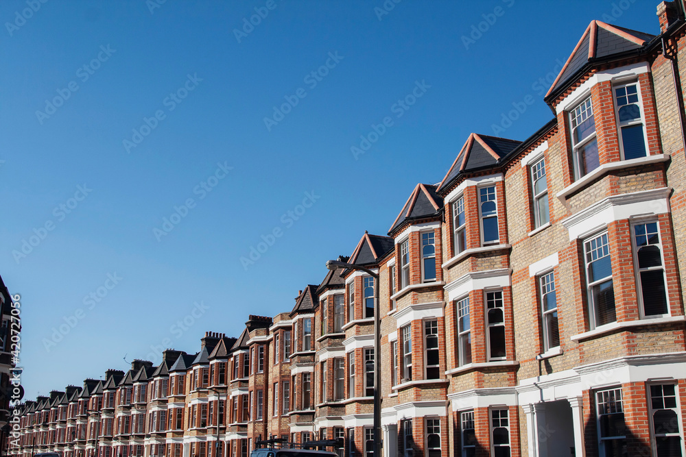 A curve of terraced houses in London on a bright sunny day. A curve of terraced houses in London on a bright sunny day.