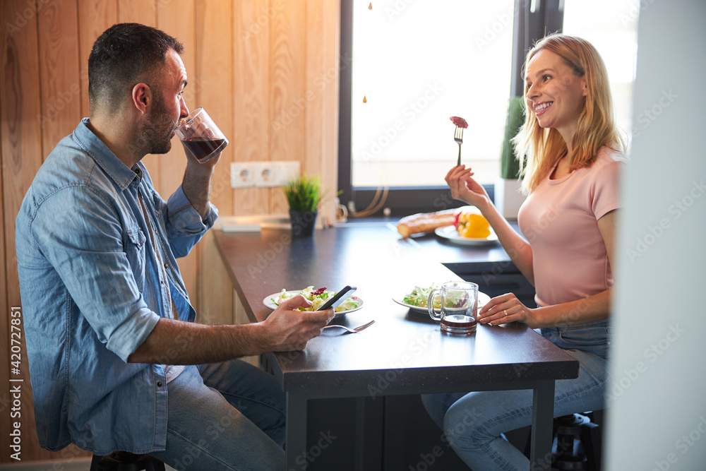 Fototapeta premium Beautiful happy couple enjoying breakfast at home