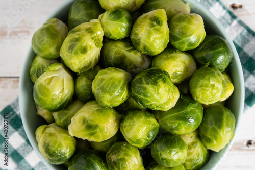Set of brussel sprouts in a bowl on white wooden table © chandlervid85