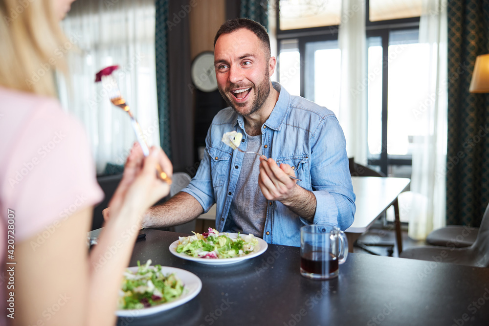 Cheerful man enjoying breakfast with wife at home Cheerful man enjoying breakfast with wife at home