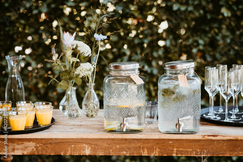 lemonade jars with dispenser on a rustic wooden table