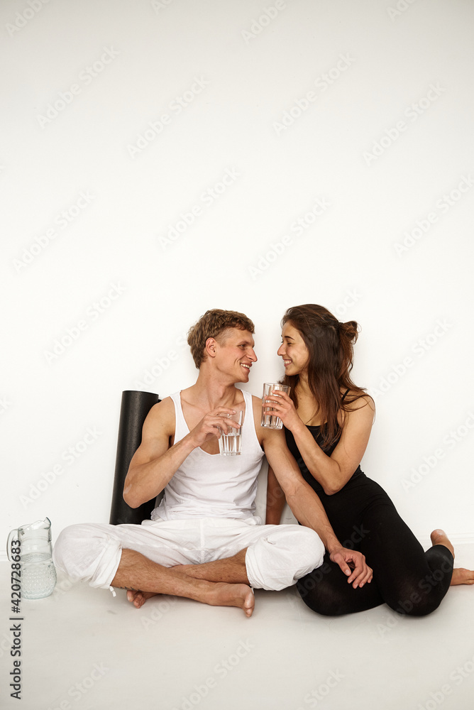 Young Healthy Couple Relaxing After Workout In the Gym Young Healthy Couple Relaxing After Workout In the Gym