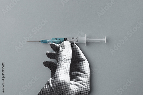 Hand holding a vaccine