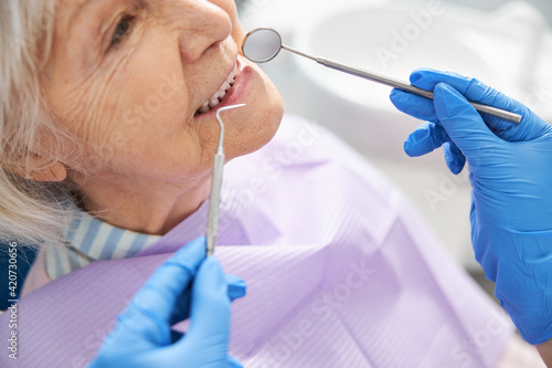Inspection of teeth performed with dental mirror and probe