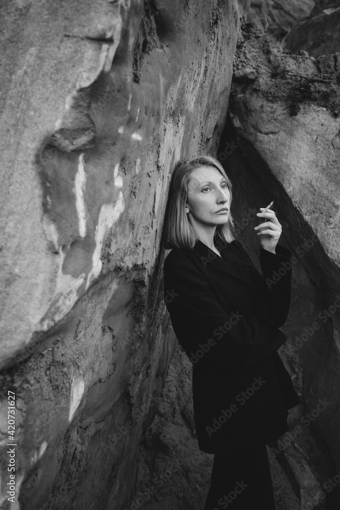 Lady smoking in the rocks. Lady smoking in the rocks.