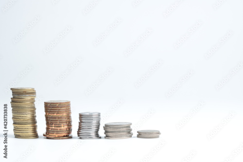 stacks of golden and silver coloured coins in decending order isolated in white background stacks of golden and silver coloured coins in decending order isolated in white background