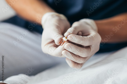A Dentist Holding an Artificial Tooth photo