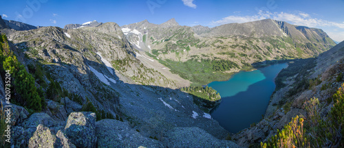 View of a deep mountain gorge with a lake, summer travel